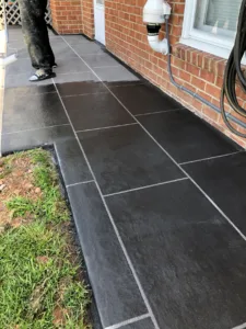 an image of a large black slab concrete coating it looks very clean and modern with narrow grout lines of light grey