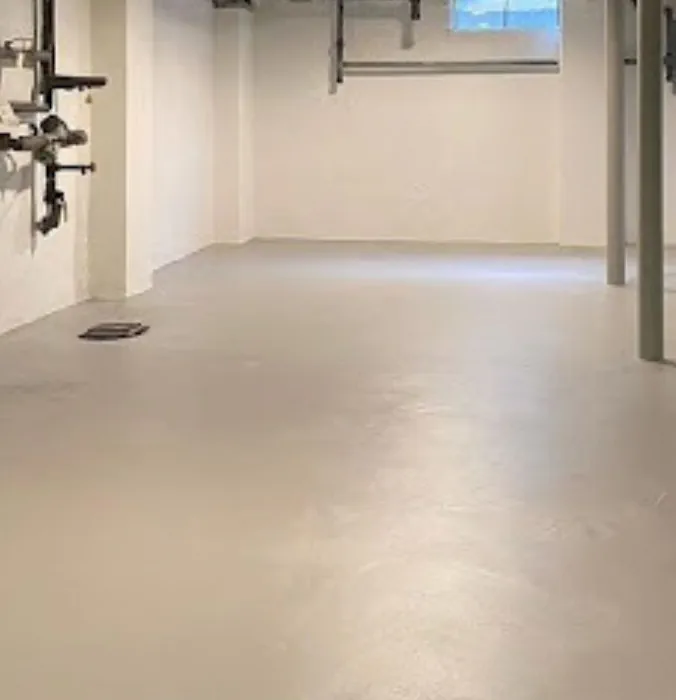 an image of a basic but attractive all white, clean and sealed basement floors and walls, it looks kinda sci-fi