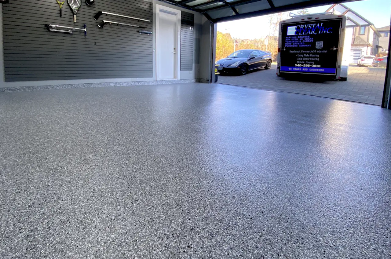 an image of a Epoxy Finish Garage Floor, brand new installation and it's a speckled finish of grey and white, it looks shiny and its a great look for a garage floor
