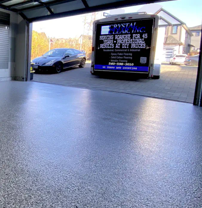 an image of a Epoxy Finish Garage Floor, brand new installation and it's a speckled finish of grey and white, it looks shiny and its a great look for a garage floor