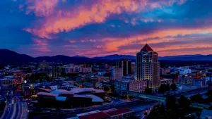 a beautiful image of Roanoke at night, lit up by various city lights, its very colorful